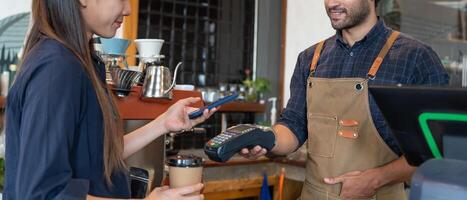 Women use smartphone to scan QR code for order menu in cafe restaurant with a digital delivery. Choose menu and order accumulate discount. E wallet, technology, pay online, credit card, bank app photo