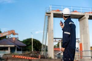 maintenance and inspector, Maintenance engineers are using walky talky to inform the results of inspection of buildings and structures. Irrigation engineers are exploring sluice system photo
