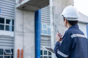 maintenance and inspector, Maintenance engineers are use walky talky to inform the results of inspection of buildings and structures. Irrigation engineers are exploring sluice systems photo