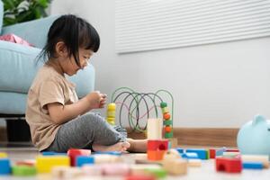 Happy Asian child play and learning toy blocks. children are very happy and excited at home. child have a great time playing, activities, development, attention deficit hyperactivity disorder photo