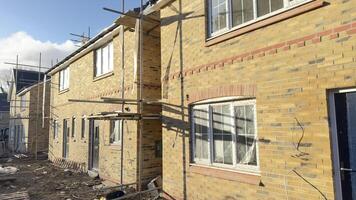 Under-Construction Brick Townhouses with Scaffolding photo