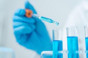 analyze biochemical samples in advanced scientific laboratory. Medical professional use dropper mix microbiological developmental of viral. Biotechnology research in science lab photo
