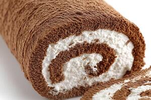 Chocolate roll with cream on a white background. Close-up. photo