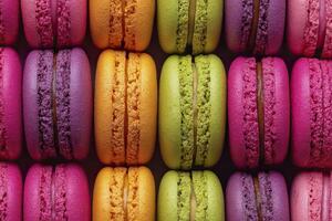 Colorful assorted macarons arranged in rows, close-up. photo