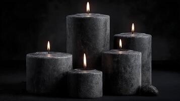 Black candles on a black background. Gothic background. photo