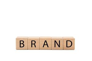Wooden blocks with BRAND text isolated on white background. Build your Brand. Brand building, success, business. Copy space and clipping path. photo