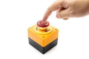 Hand pressing Emergency stop button. Big Red emergency button or stop button for manual pressing. photo