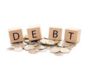 Debt Concept with Wooden Blocks and Coins. Financial Crisis and Money Problem Symbol isolated on White Background. photo