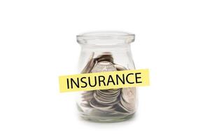Coins in glass money jar with INSURANCE word on label, Financial Insurance Concept. isolated on white background. Secure Money Planning. Health and Wealth Insurance. photo