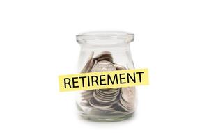 Coins in glass money jar with RETIREMENT word on label, financial concept. isolated on white background. Retirement Savings and Financial Security. photo