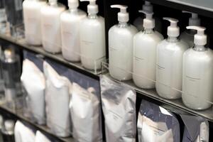 Refill to reduce plastic waste. soap or shampoo for refill. plastic bottles for refill liquid soap, shampoo and other products. Reusable Bottles for Soap and Shampoo in Zero Waste Lifestyle. photo