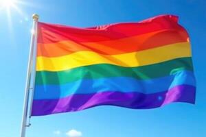 A rainbow flag flying in the wind photo