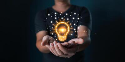 man hand holding power lightbulb and pretend to think, inspiration, creativity and imagination concept, innovation technology success business. Digital transformation. Ai technology photo