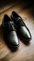 Black leather shoes on wooden floor photo