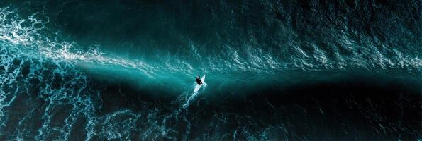 An aerial view of a surfer riding a wave photo