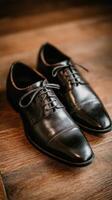 Black dress shoes on a wooden floor photo