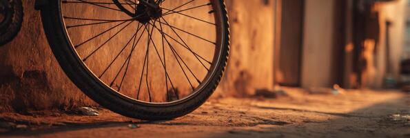 A bicycle wheel leaning against a wall photo