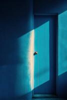 A blue door with a wooden handle and a light shining through the window photo
