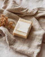 A soap bar on a linen cloth with dried flowers photo
