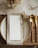 A place setting with a napkin and goldware photo