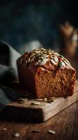 A loaf of pumpkin bread with seeds on a wooden cutting board photo