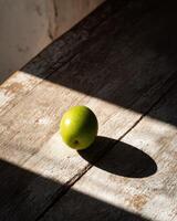 A green apple sitting on a table photo