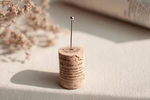 A pin with a cork sitting on top of a book photo