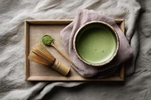 Matcha green tea with bamboo whisk and matcha powder photo
