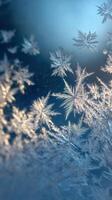 Snowflakes on a window with blue sky photo