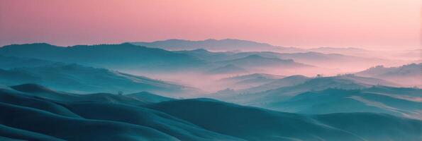 A pink sky and blue mountains in the distance photo