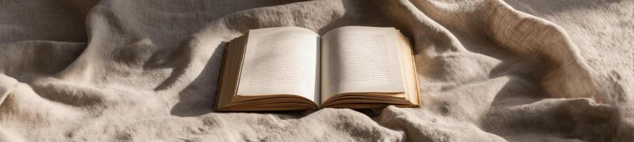 An open book is sitting on top of a brown cloth photo