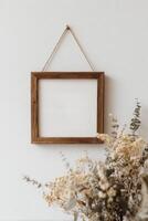 Wooden frame mockup on white wall photo