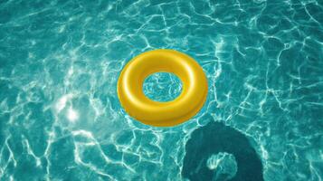 A yellow life ring floating in a pool photo