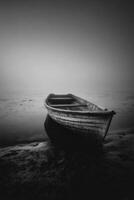 A black and white photo of a boat on the shore