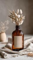 Dry flowers in a glass bottle on a cloth photo