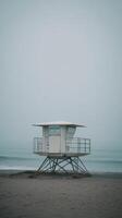 A lifeguard tower on the beach in the fog photo