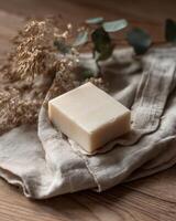 A soap bar on a cloth with dried leaves photo