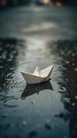 Paper boat floating in water on wet surface photo
