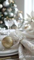Elegant holiday table setting with gold ornament and crystal glassware photo