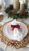 Festive holiday table setting with elegant red accents and seasonal decorations photo