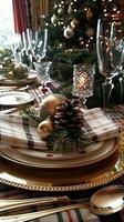 Elegant christmas table setting with pinecones and gold accents near decorated tree photo