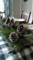 Elegant winter table setting with pinecone and evergreen centerpiece for holiday dining photo