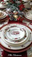 Elegant christmas table setting with festive dinnerware and holiday decor photo