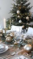 Elegant holiday dining with festive christmas tree and gold decor photo