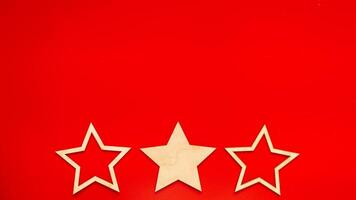 Wide banner Red background with three wooden stars at the bottom in a row photo