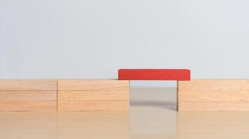 Red wooden block connecting both sides. Concept of problem solving, leadership, key contribution, and standing out by enabling connection and progress. photo