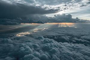 Stratocumulus clouds illuminated by sunlight above a soft cloud cover during twilight photo