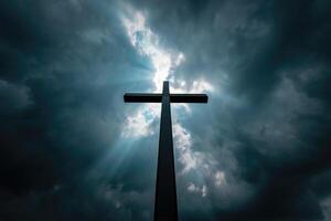 Dark clouds surround a cross silhouetted against a dramatic sky photo