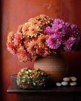 Colorful flower arrangement in a rustic vase on a wooden table with stones and greenery photo