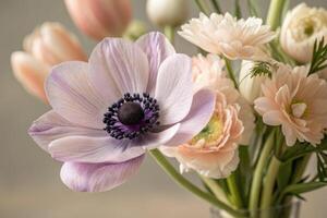 A stunning close-up of a delicate anemone and other beautiful flowers in a vibrant bouquet. photo
